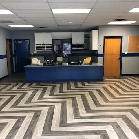Reception area with a chevron-pattern wood-look plank floor