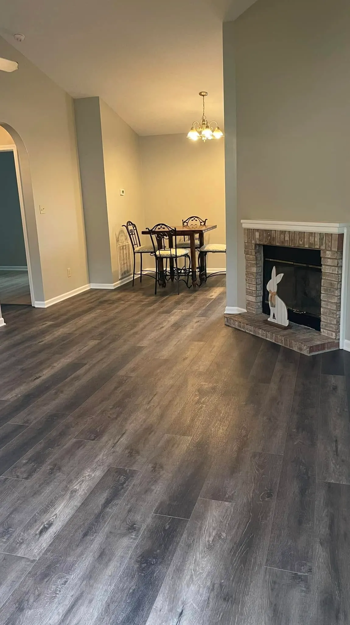 Dining area with gray luxury vinyl plank flooring and a fireplace