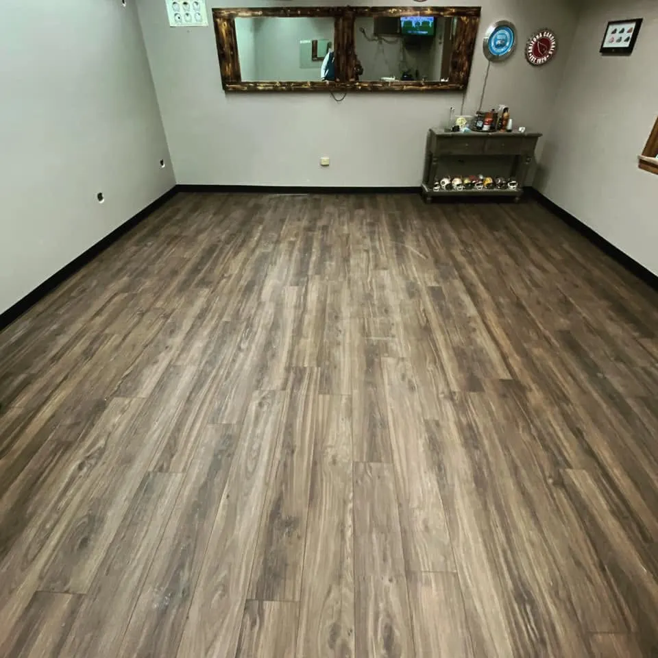 Large open room with warm gray luxury vinyl plank flooring