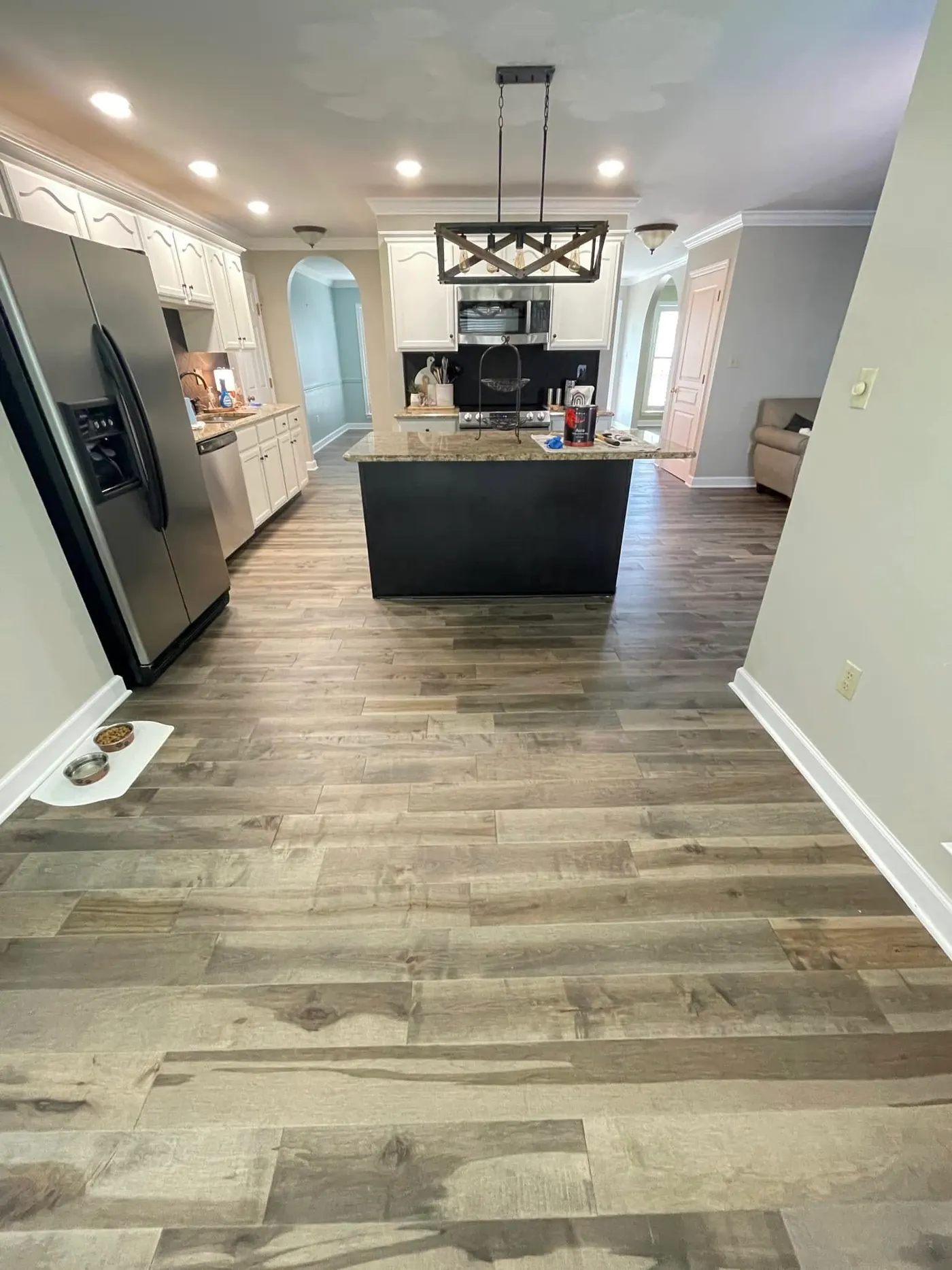 Kitchen with island and wood-look luxury vinyl plank flooring
