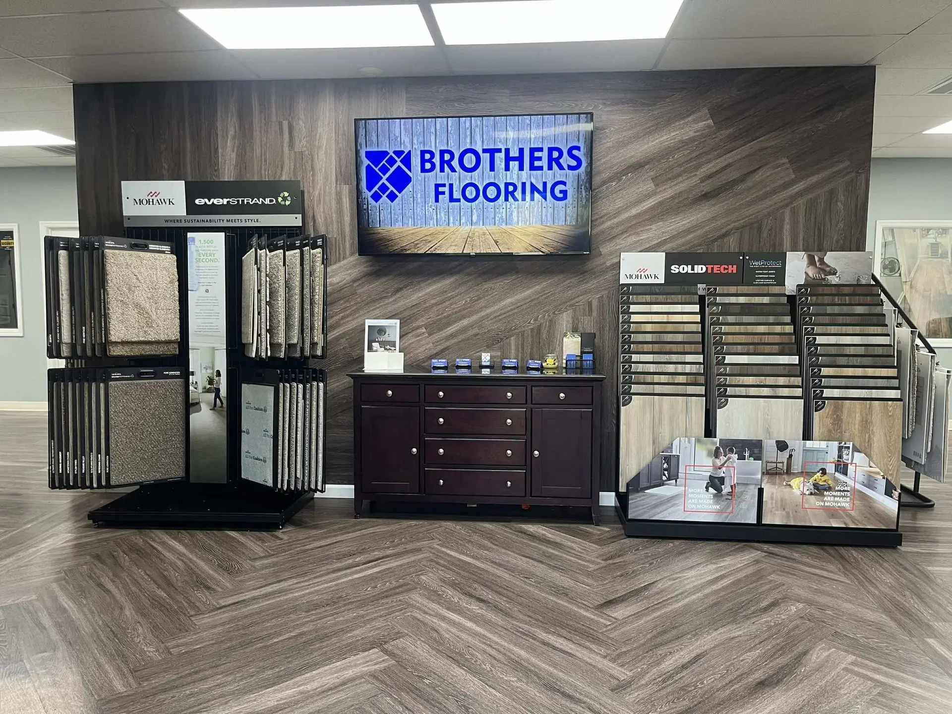 Inside the Brothers Flooring showroom — carpet and luxury vinyl displays around the Brothers Flooring sign